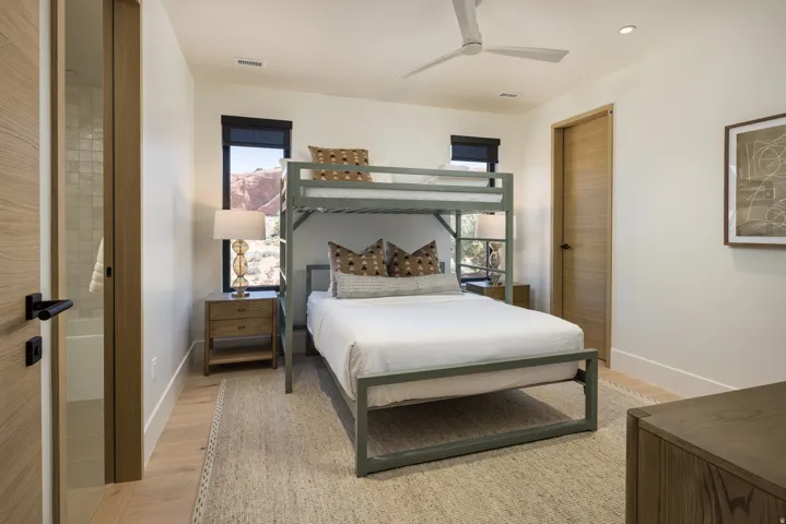 Light wood-finish flooring, a contemporary ceiling fan, and recessed lighting