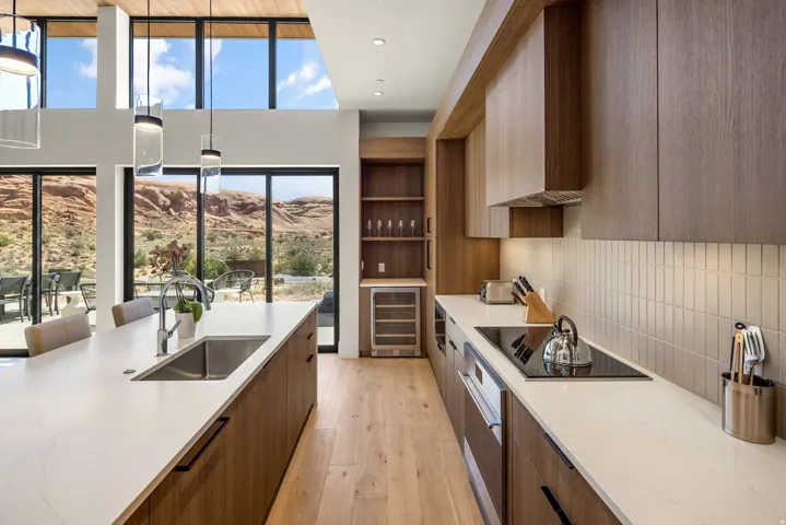 Modern kitchen featuring wood-finish cabinetry, light wood-finish flooring, and light countertops