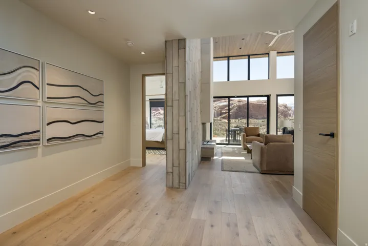 Hallway featuring light wood-finish flooring, recessed lighting, and a neutral color palette