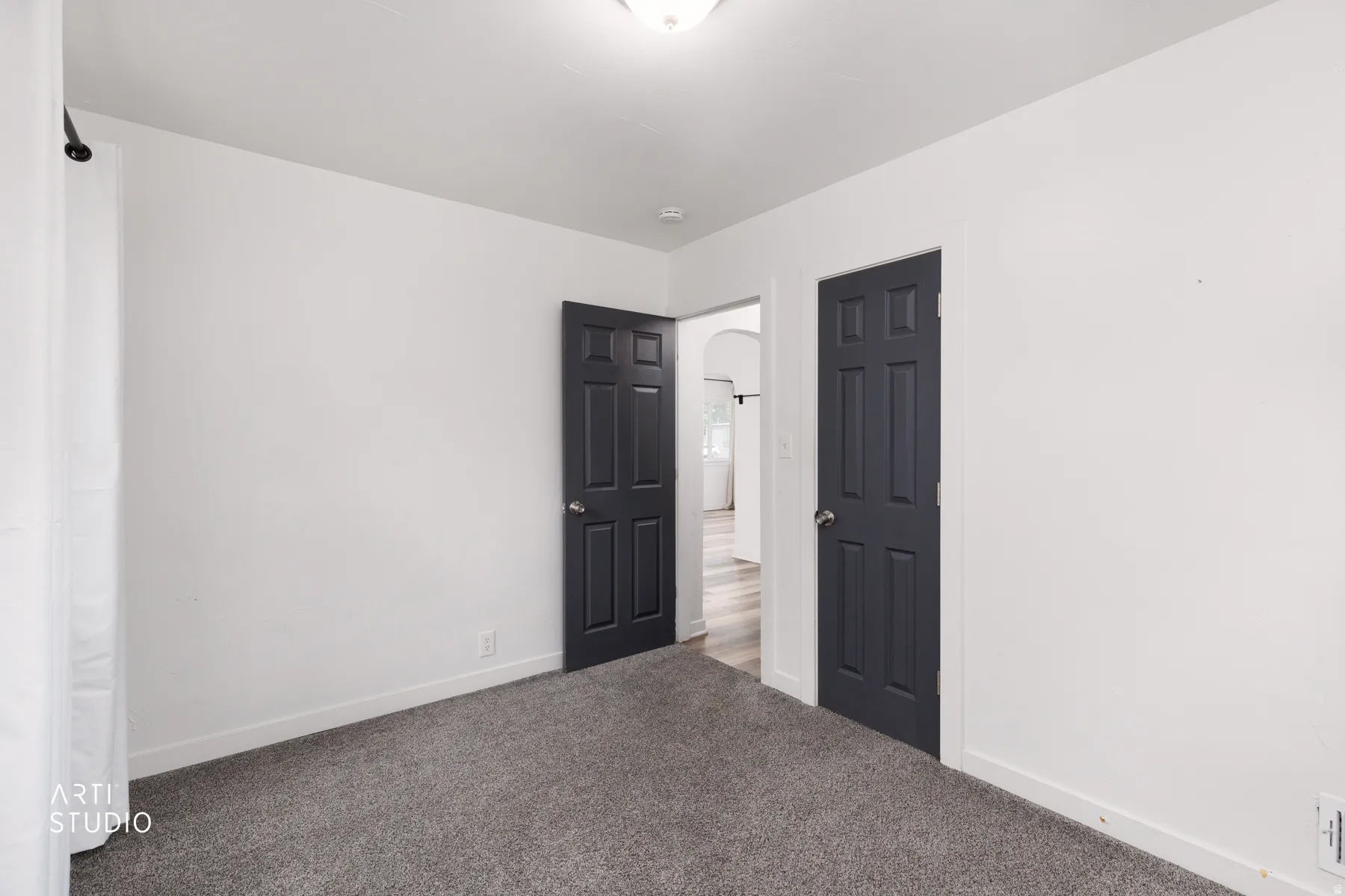 Neutral wall finishes with contrasting dark panel doors