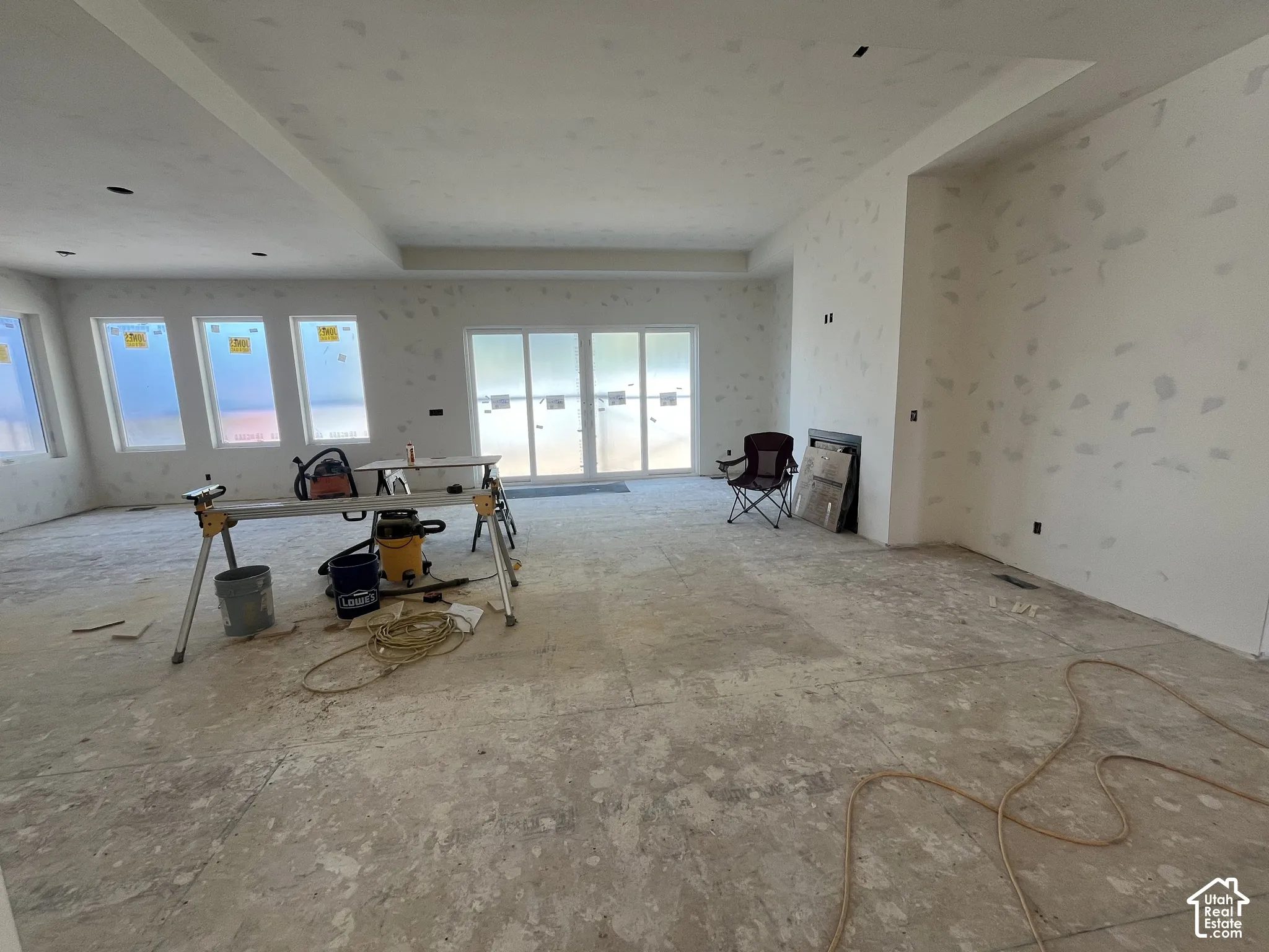 Integrated fireplace, recessed lighting, and multiple large windows