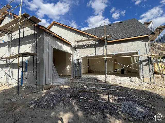 New construction with a two-car garage opening, a single-car garage opening, and a newly installed shingle roof