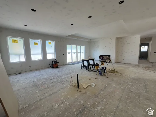 Spacious interior featuring recessed lighting, multiple windows, and a sliding glass door