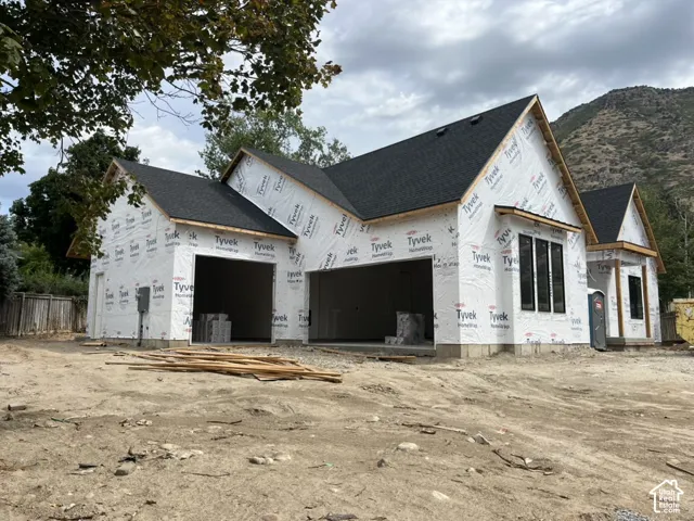 New construction featuring a multi-gabled roofline and black-framed windows