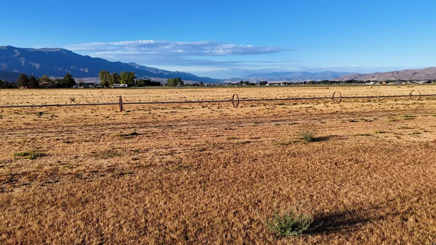 Expansive undeveloped land featuring a clear horizon and distant mountains