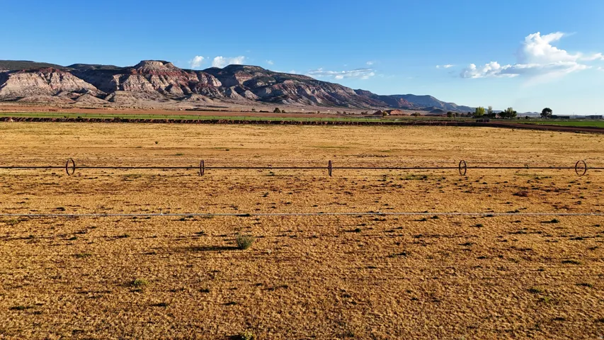 Expansive land parcel featuring open terrain and distant mountain ranges