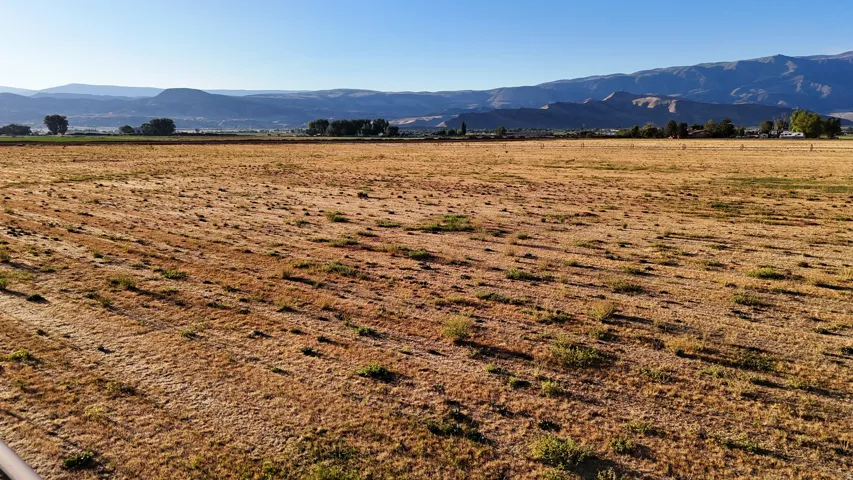 Expansive open field with distant mountain ranges