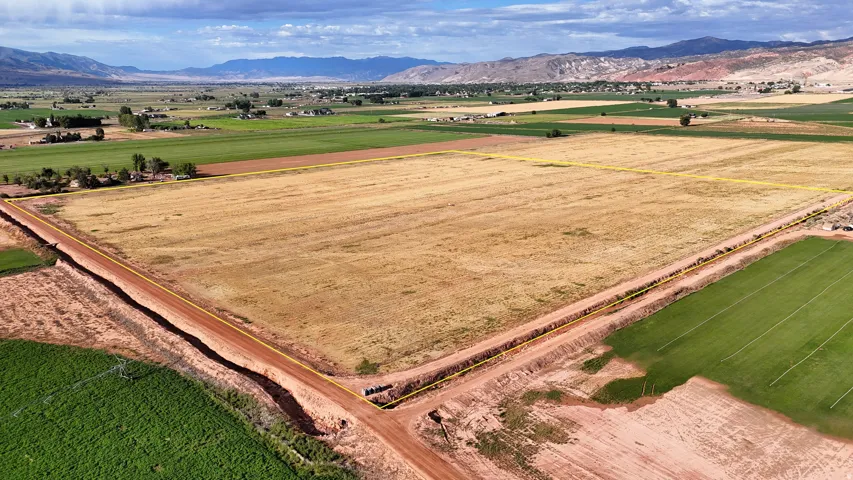 Expansive agricultural land featuring a rectangular parcel with defined boundaries and surrounding fields