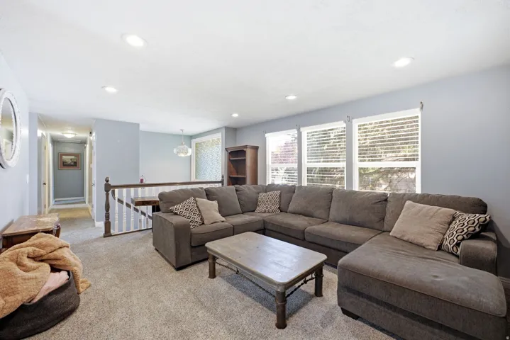 Recessed lighting illuminating the carpeted living area