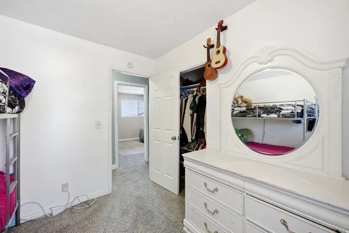 Plush carpet flooring and a built-in closet with ample storage