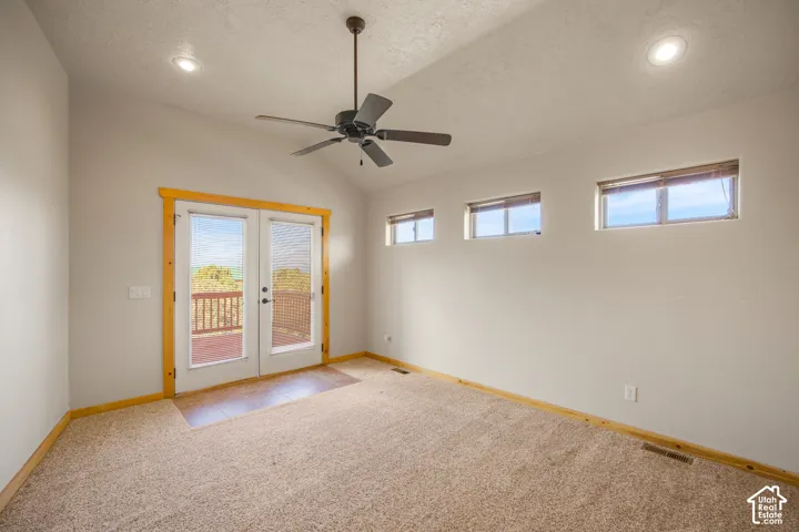 Vaulted ceiling with recessed lighting and ceiling fan