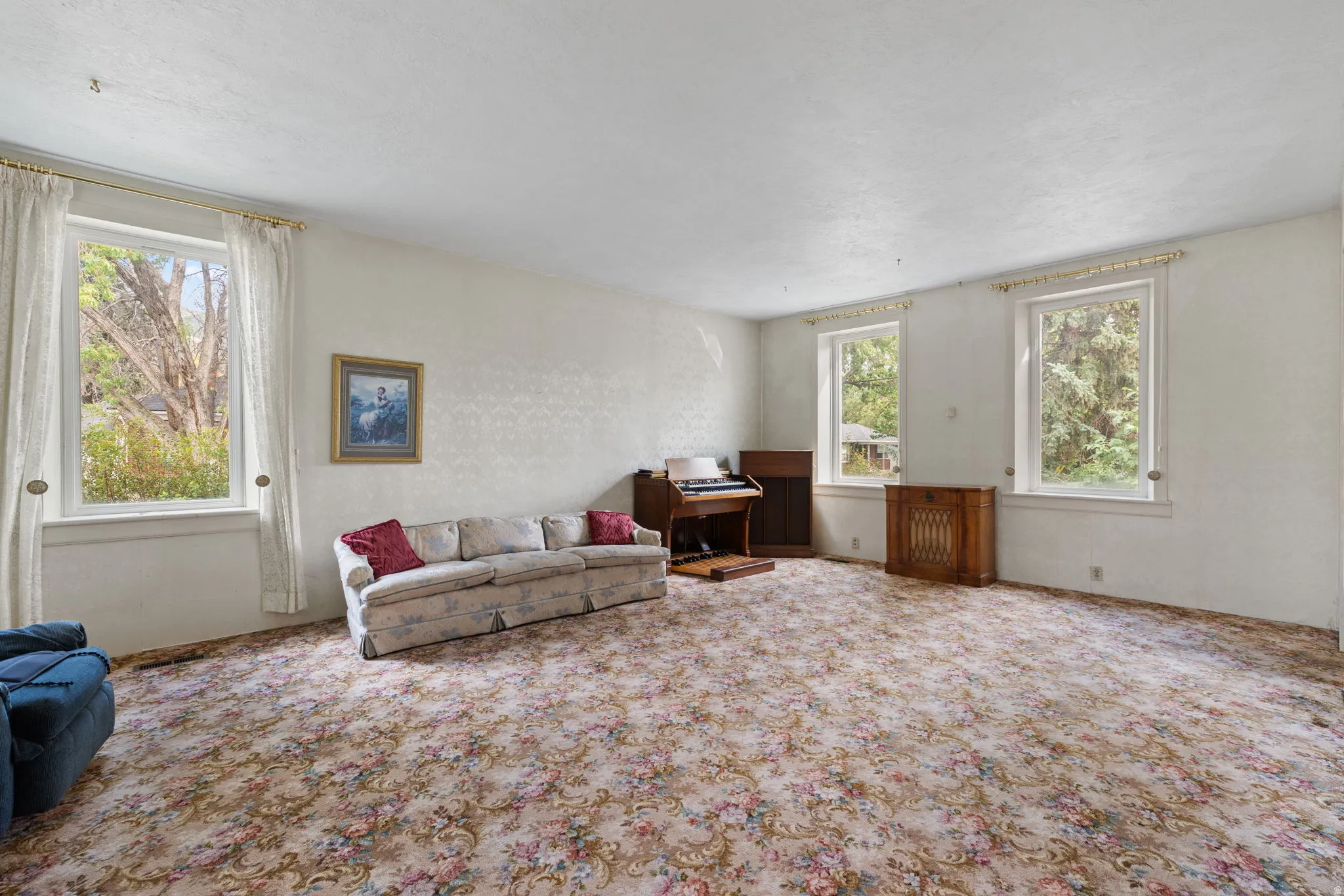 Spacious room with multiple windows providing natural light