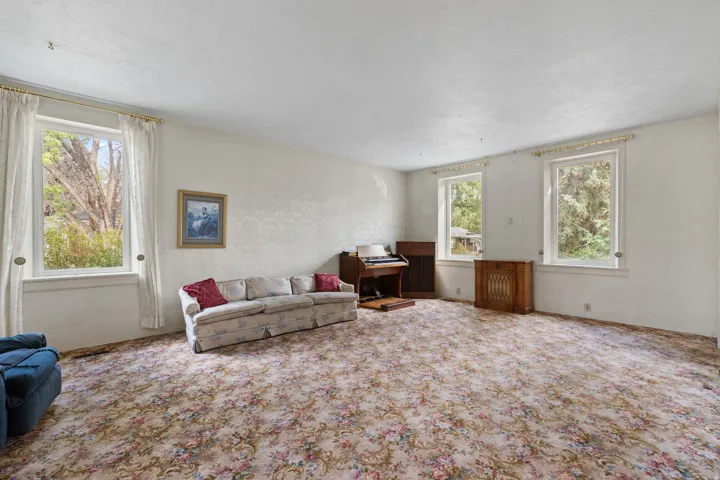 Spacious room with multiple windows providing natural light