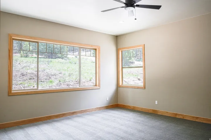 Recessed lighting, ceiling fan, wood-frame windows, wood-finish trim, and carpeted flooring