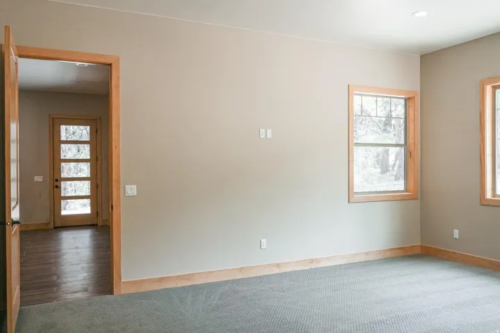 Recessed ceiling lighting, wood-finish flooring, light wood trim, and a multi-pane door