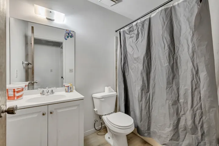 White vanity with integrated sink, chrome faucet, and white cabinetry