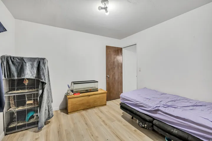 Recessed lighting, wood-finish flooring, and a solid core interior door