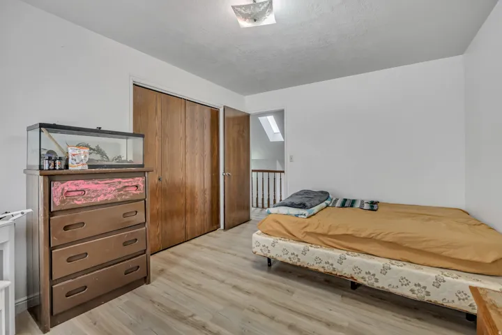 Light wood-finish flooring with white walls