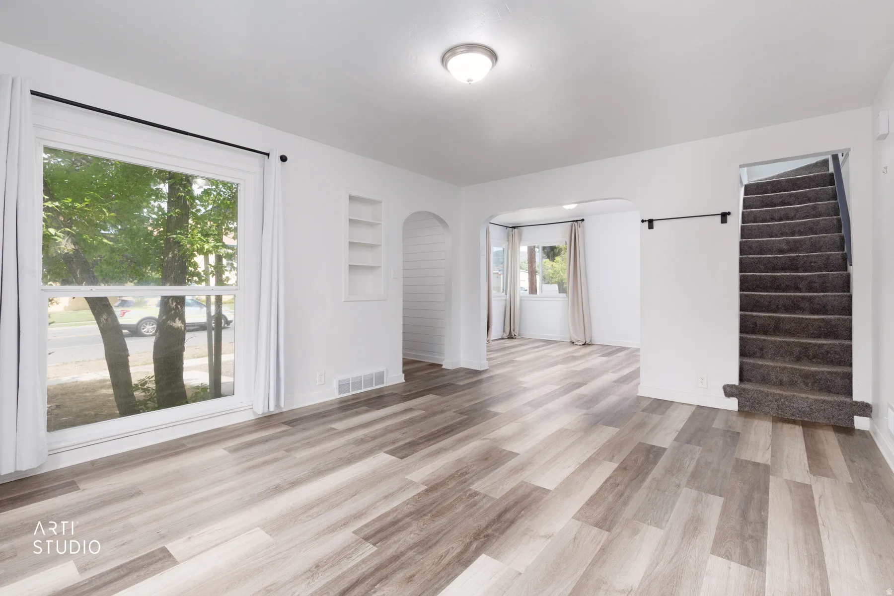 Recessed shelving, durable wood-finish flooring, and an arched entryway