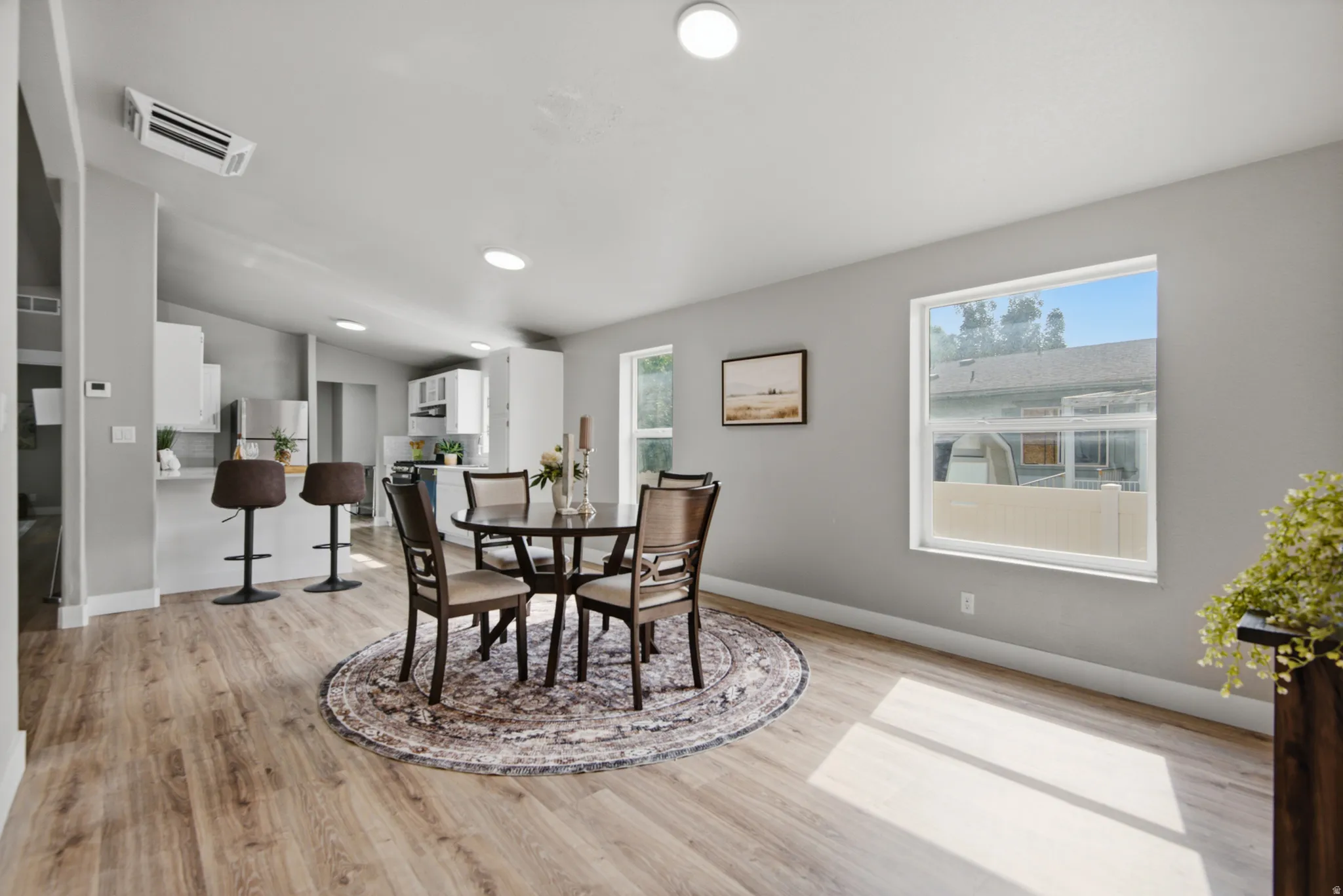 Wood-finish flooring throughout, complemented by a light gray wall color