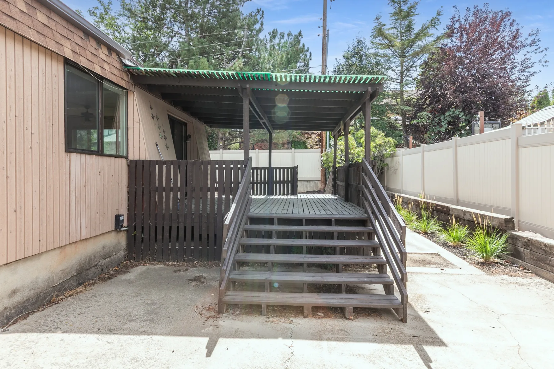 Covered deck with stairs and privacy fencing