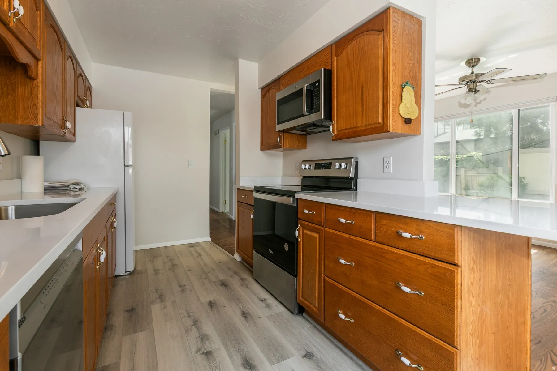 Wood-finish cabinetry paired with light countertops