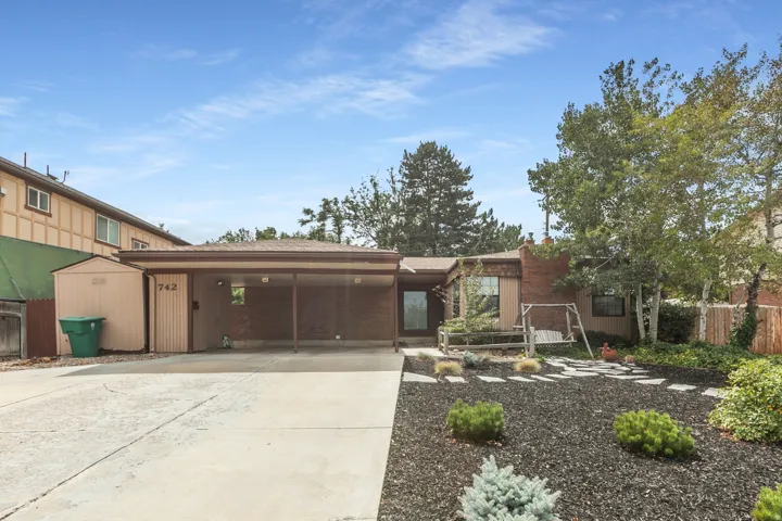 Brick exterior with a covered carport