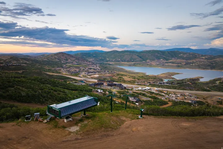 Expansive mountain landscape with a ski lift structure