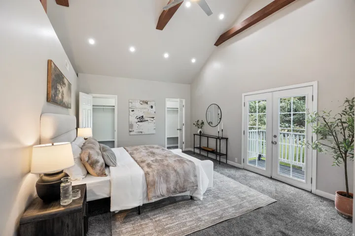 Vaulted ceiling with exposed wood beams, recessed lighting, and a ceiling fan