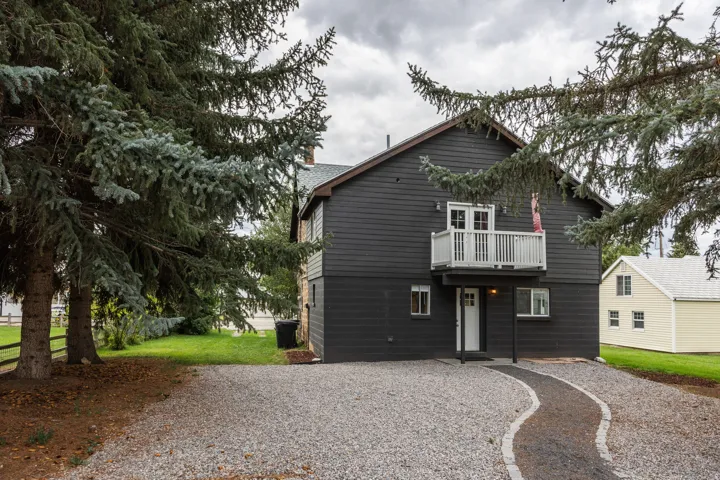 Dark-toned exterior siding with white trim accents