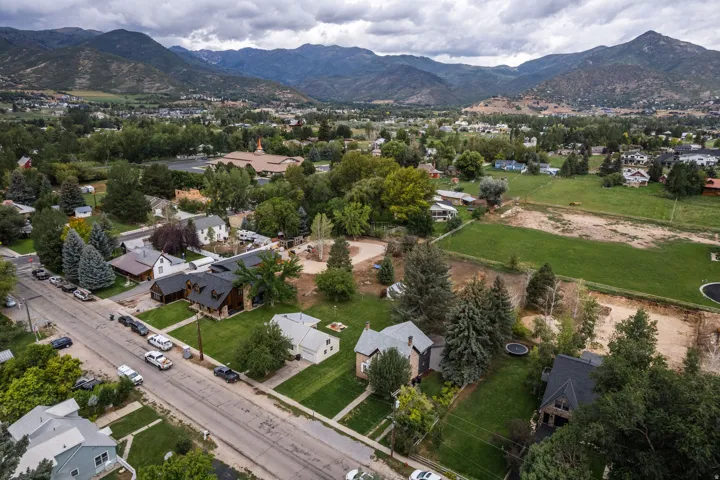 Residential neighborhood featuring mature trees and a manicured lawn