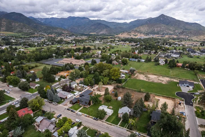 Expansive mountain backdrop with a residential area and green spaces