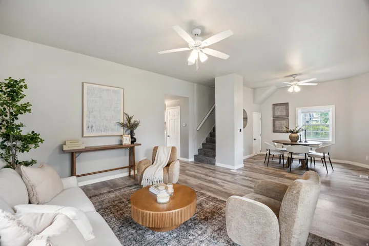 Open-concept living area featuring wood-finish flooring, recessed lighting, and ceiling fans