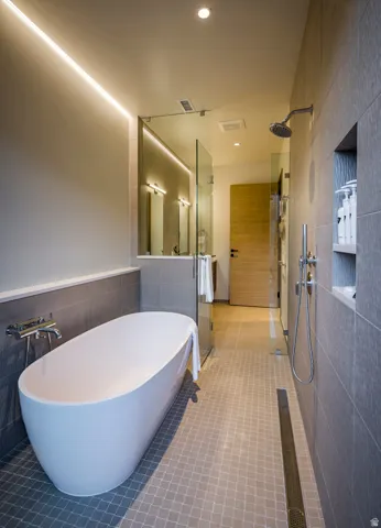 Contemporary bathroom featuring a freestanding soaking tub with wall-mounted fixtures