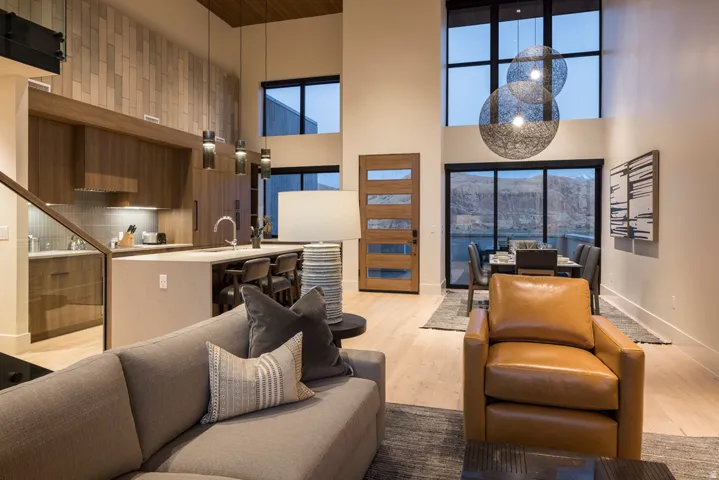 Open-concept living area featuring high ceilings and wood-finish flooring
