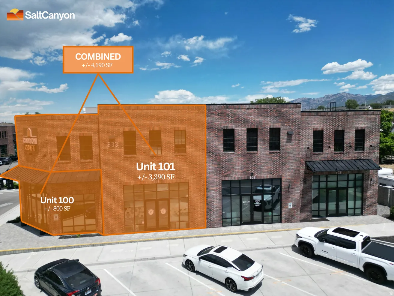 Brick facade building featuring multiple large windows and a distinct corner unit