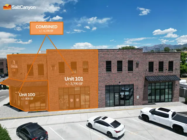 Brick facade building featuring multiple large windows and a distinct corner unit