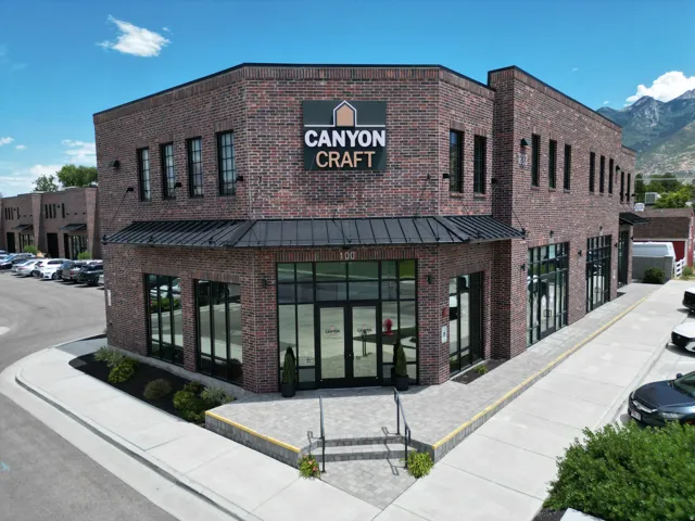 Brick exterior with a black metal awning and large storefront windows