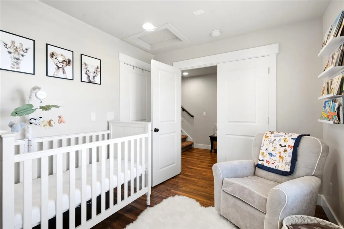 Wood-finish flooring, recessed lighting, white interior doors, and built-in shelving