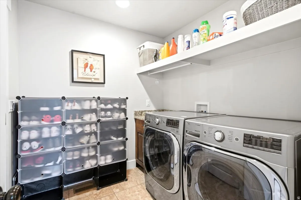 Laundry area featuring a built-in shelf, tiled flooring, and a countertop surface