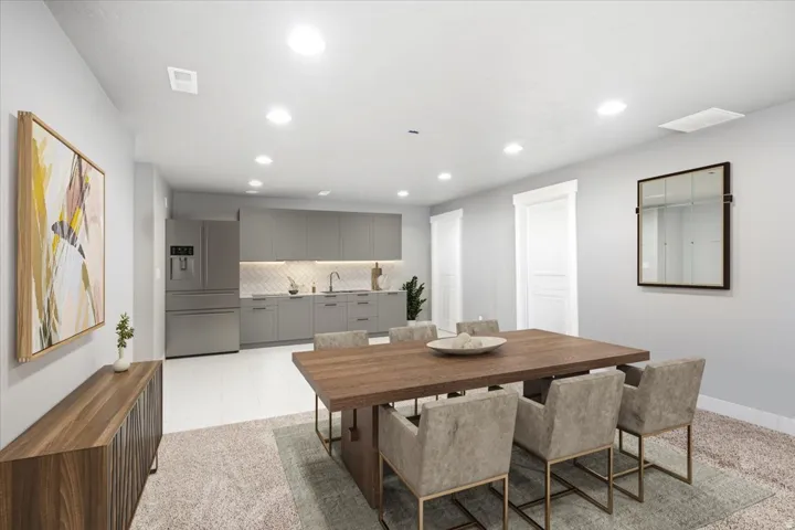 Recessed ceiling lighting, stainless steel appliances, gray cabinetry, tile backsplash, and white wood-finish flooring