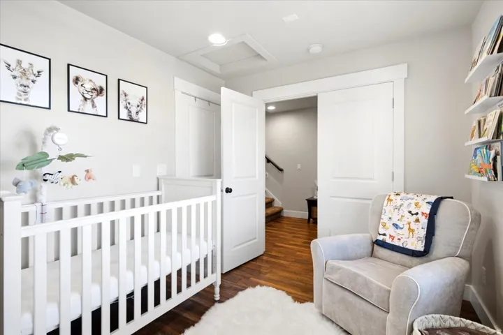 Wood-finish flooring, recessed lighting, white interior doors, and built-in shelving