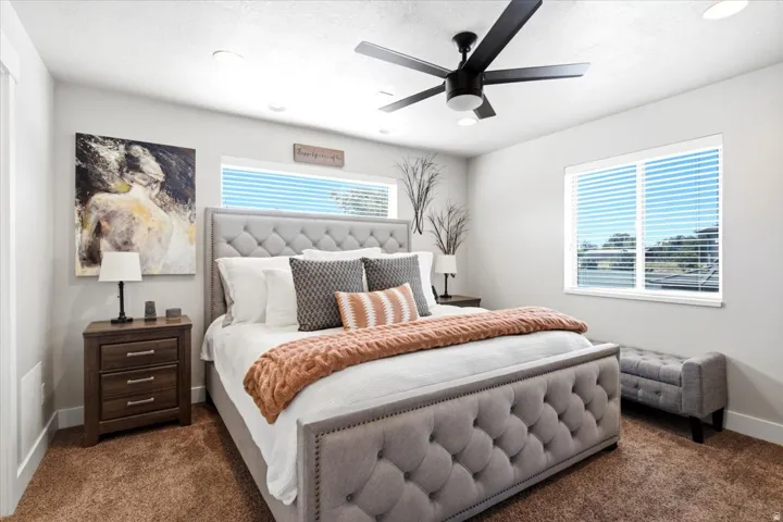 Carpeted flooring with dual windows, recessed lighting, and a ceiling fan