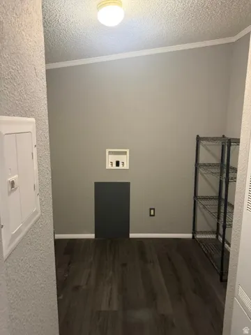 Wood-finish flooring, overhead flush mount lighting, and crown molding