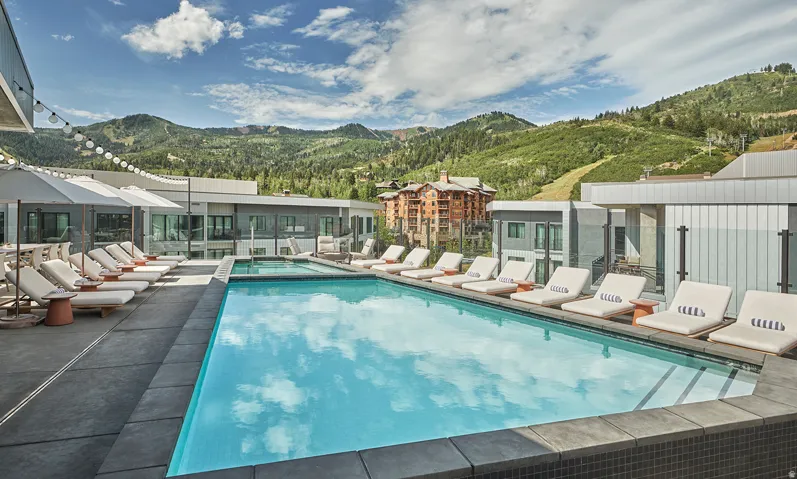 Outdoor pool and lounge deck at Pendry Park City with Park City Mountain ski terrain as the backdrop.