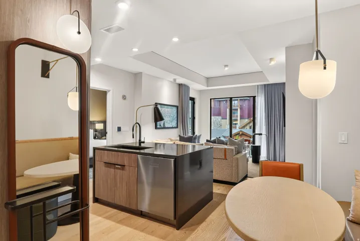 Open-concept great room and kitchen with island seating, dining and mountain light throughout the residence.