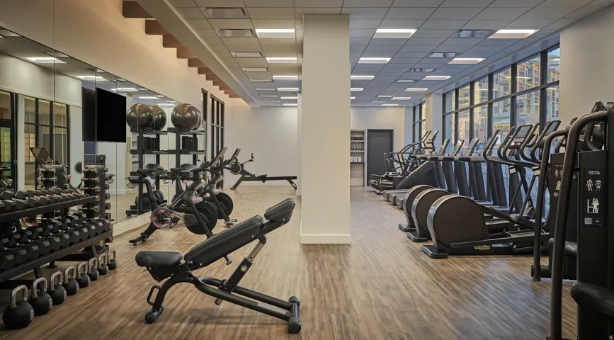 Fitness center at Pendry Park City with free weights, strength equipment and cardio overlooking Canyons Village.