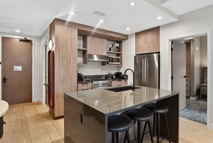 Kitchen and entry hall of Residence 3210, a two-bedroom ski-in, ski-out condo at Pendry Park City in Canyons Village.
