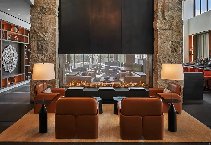The apres lounge at Pendry Park City is built around a double-sided stone fireplace, an easy landing after last chair.
