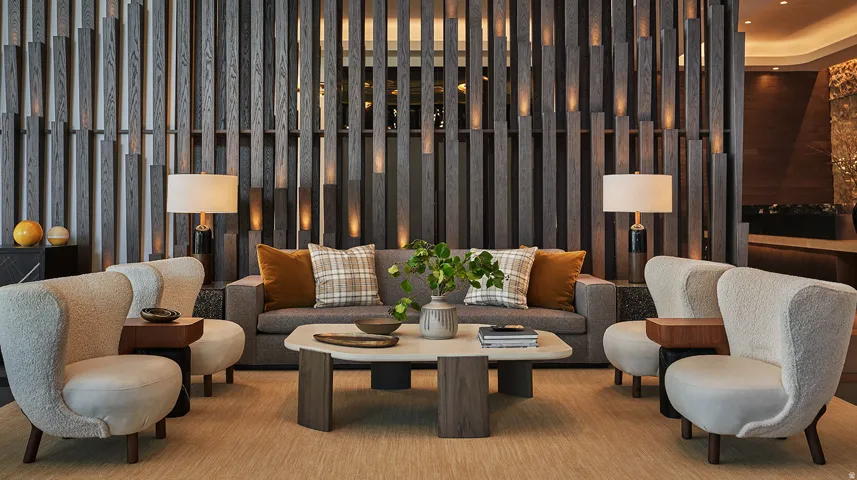 Lobby seating with a fluted wood feature wall at Pendry Residences Park City, a quiet place to land after a ski day.